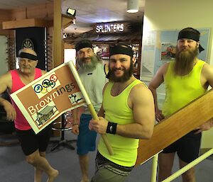 The Browning’s Olympic team posing in their fluro singlets with the captain holding the team flag.