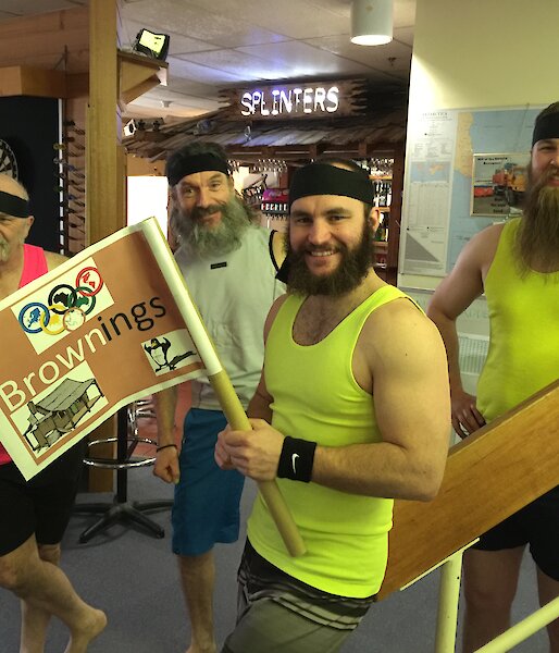 The Browning’s Olympic team posing in their fluro singlets with the captain holding the team flag.