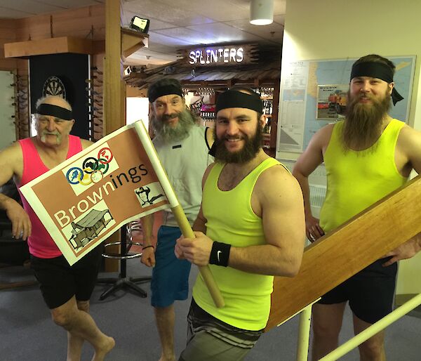 The Browning’s Olympic team posing in their fluro singlets with the captain holding the team flag.