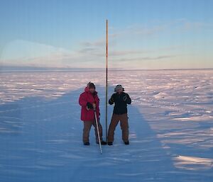 AJ and Danny standing next to a marker cane they have just installed.