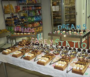 The deserts table presented for the dinner with the words “Friends, Dreams and Casey Station” made from meringue standing upright.