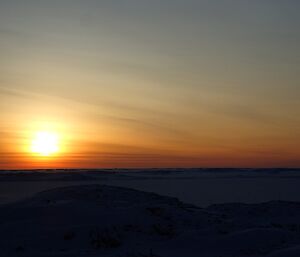 The sun behind low cloud producing many different shades of colour.