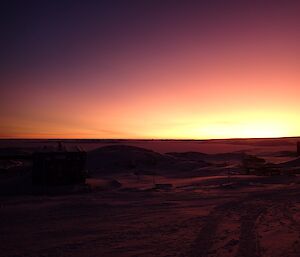 The sun producing an awesome variation of reds, yellows and orange colours as it slowly rises.