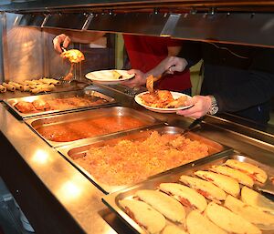 Mexican food showing Taquitos, Enchiladas, Chilli Con Carne, Rice and Quesadillas being served.