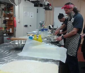 Donna smiles as Mick mixes flour.