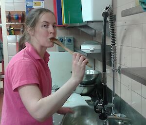 Rachel licking the mixing spoon between washing the dishes.