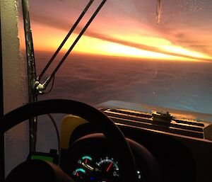 The red coloured sky sunset, looking from the seat of the tractor.