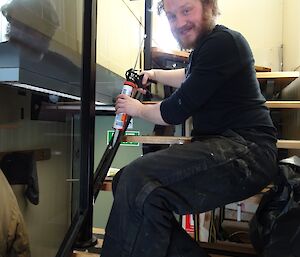 Pete sitting on the internal stairs as he is working on the balustrade