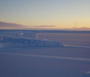 The Vanderfort glacier meeting the frozen sea ice with a blue sky background