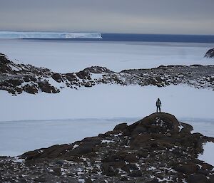 Wayne standing on a rocky mound with the Vanderfort Glacier in the background