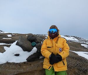 Adam standing at the monument location, small blue cylinder to his right