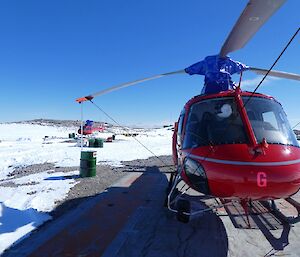 Helicopter sitting on helipad at Casey Station