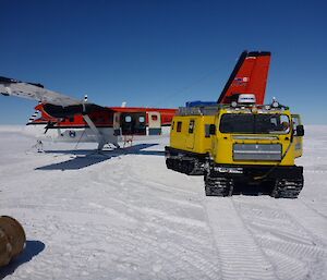 A Hägglunds is parked near a Twin Otter aircraft at Casey Skiway
