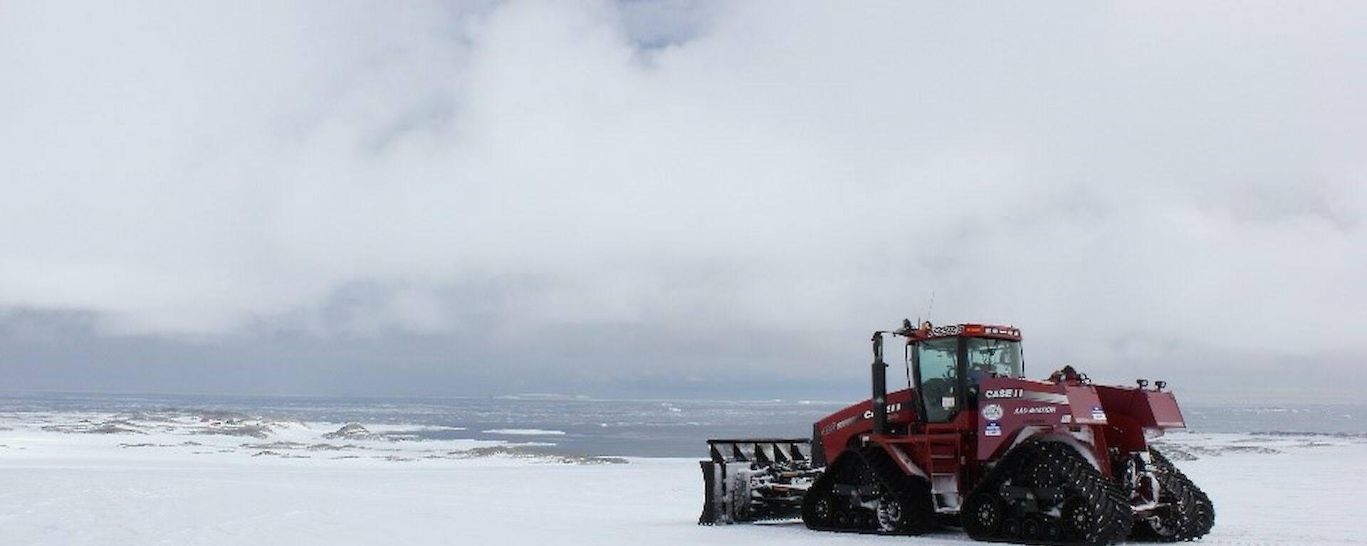 A tracked tractor pushes snow on Casey skiway