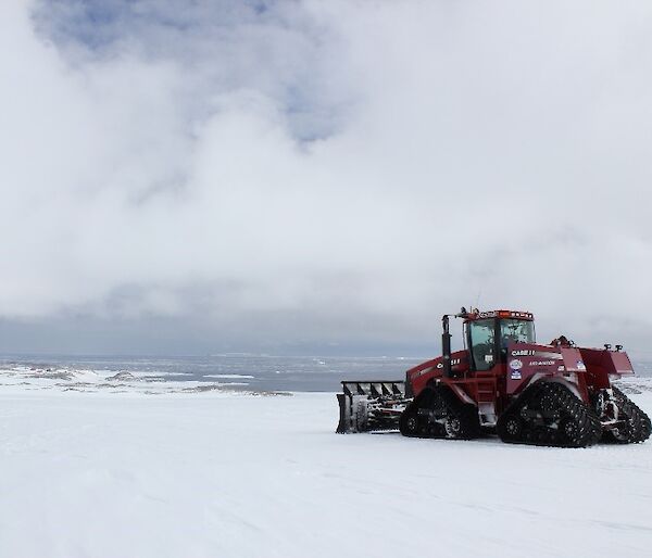 A tracked tractor pushes snow on Casey skiway