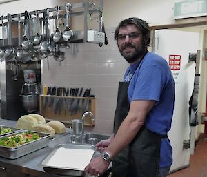 An expeditioner assists in the kitchen