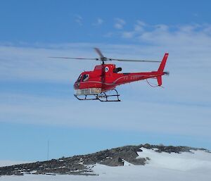 A helicopter comes into land at Casey Station