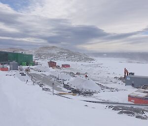 A view of the bio pile site with buildings and ice