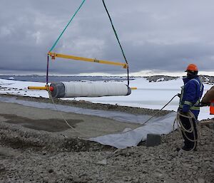 A tradesman lays the clay liner in a bio pile