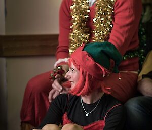 Expeditioners in Christmas costume assist Santa