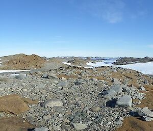 Expeditioners standing looking at a view of the rocky peninsula