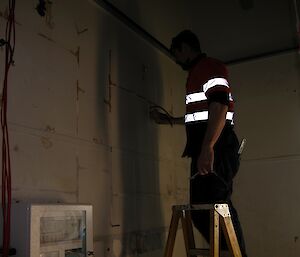 An electrician re wires the Casey balloon shed.