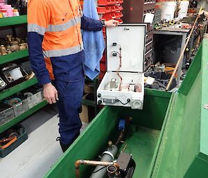 An electrician inspects a new heating system