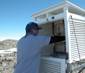 A weather observer checks the daily weather reading