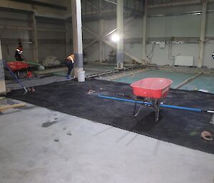 Tradesman prepare a concrete slab in the Casey utility building.