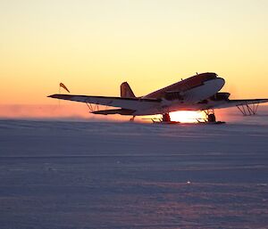 The JKB Aircraft lands as the sun sets at Casey Skiway