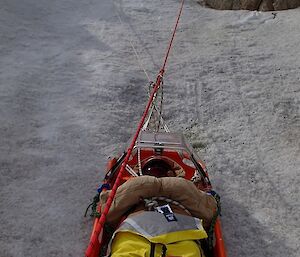 Expeditioners lower a patient down a slope as part of SAR Training