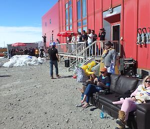 Expeditioners commentate and watch the cricket match