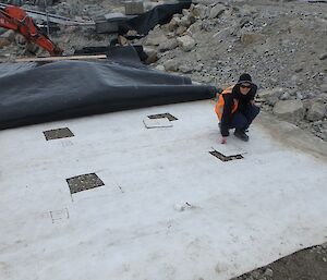 A scientist places the mat portions into the bio pile