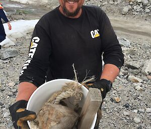 An expeditioner shows some of the rubbish they have collected