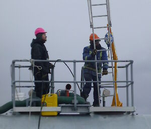 Tradesman prepare to clean the inside of one of the Station’s large fuel tanks