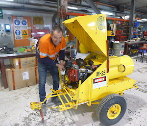 A mechanic works on a Herman Nelson heater