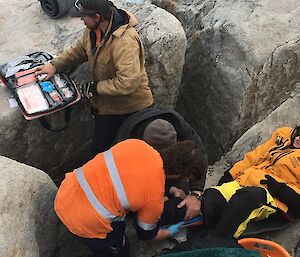 Expeditioners use a first aid kit to assist the patient