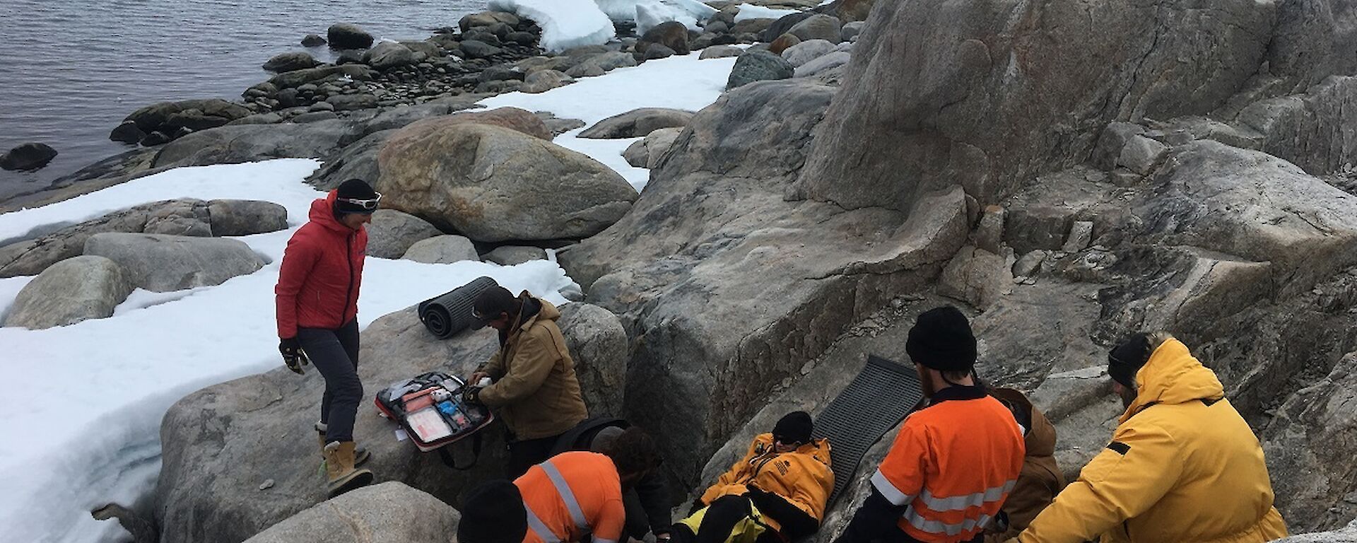 Expeditioners provide first aid to the patient during the SAR exercise