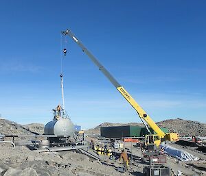 A crane is placed at the fuel tank to commence cleaning