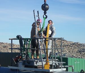 An expeditioner prepares to enter the tank that needs cleaning