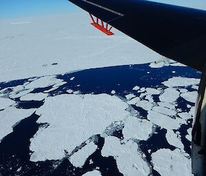 A view of the Shackleton Ice Front from a plane — broken ice in water