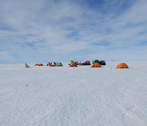 The Field Camp after being set up — tents on the ice with vehicles behind them.