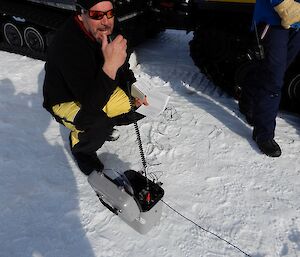 An expeditioner uses the HF radio