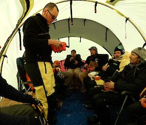 An expeditioner demonstrates how to use a Satellite phone