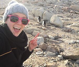 An expeditioner checks out two penguins