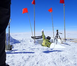 An expeditioner retrieves an ice sample