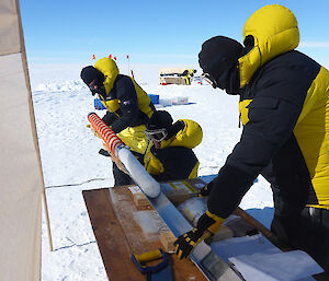 expeditioners place ice core samples for packaging