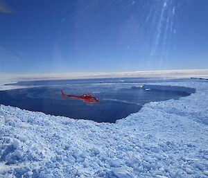 A view of a helicopter flying over the Vanderford Glacier