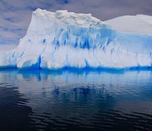 An iceberg is reflected off the water near Casey Station