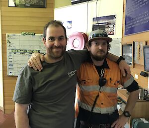 Two expeditioners standing with arms around each other